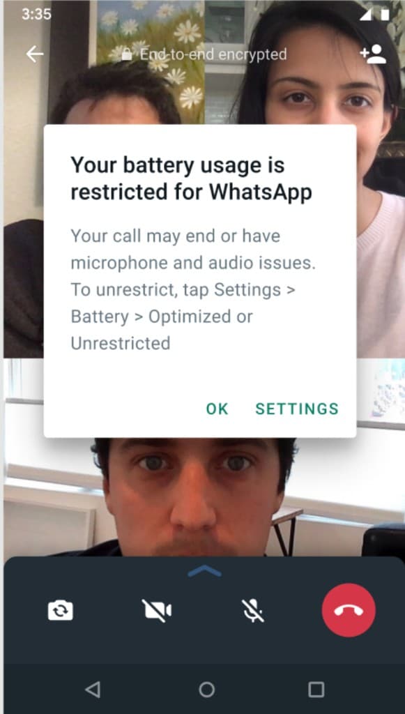 Android video call screen with a warning dialog explaining that battery usage is restricted for WhatsApp and a Settings button to unrestrict it